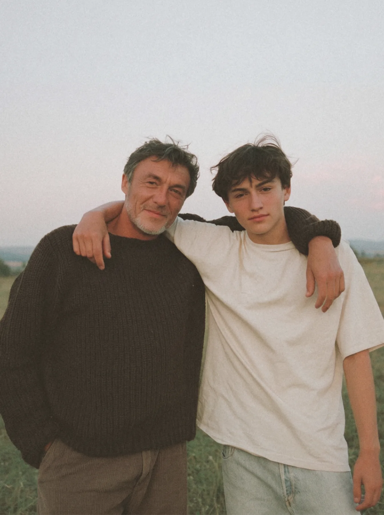 Father and son standing together outside