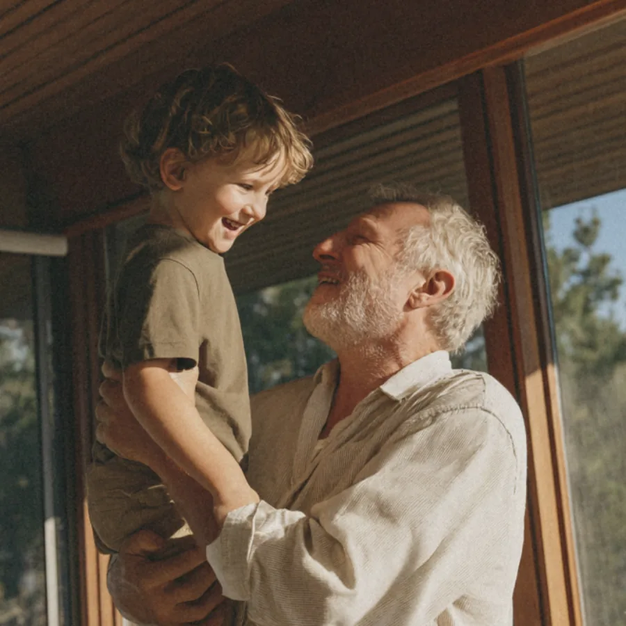 Older adult laughing with a child